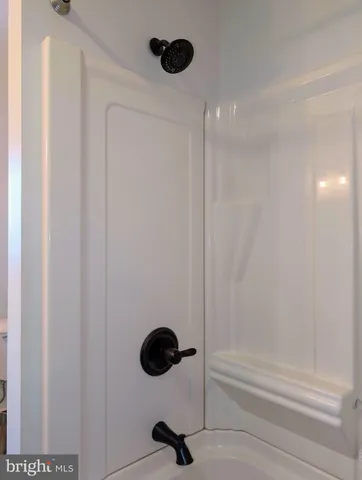 a view of a green field with trees in the background