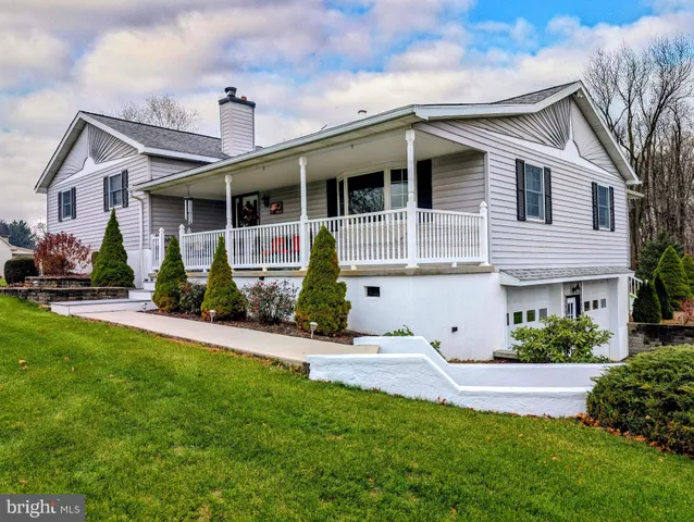 a wooden bench sitting in front of a house
