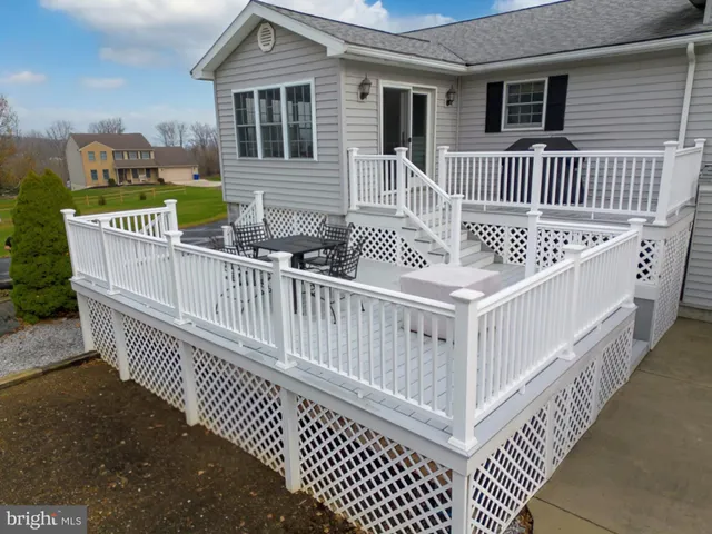 a kitchen with stainless steel appliances granite countertop a table chairs stove and refrigerator