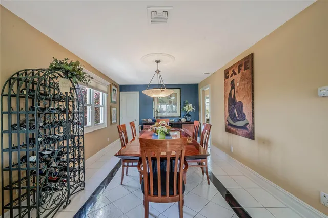 a dining room with furniture window and wooden floor