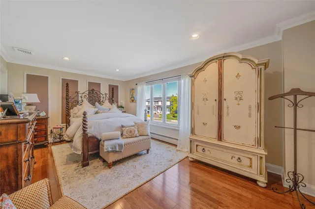 a bedroom with furniture and wooden floor