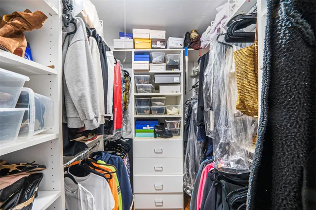 a living room with furniture a clock on wall and a window