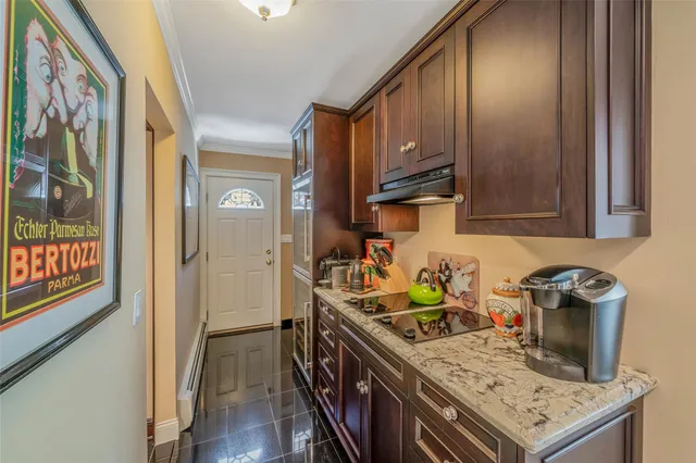 a dining area with furniture a kitchen and chandelier