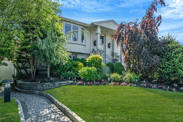 a front view of a house with a garden