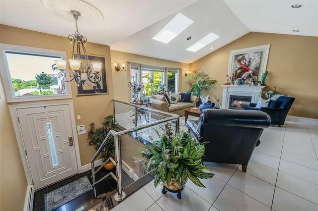 a living room with furniture a window and a chandelier