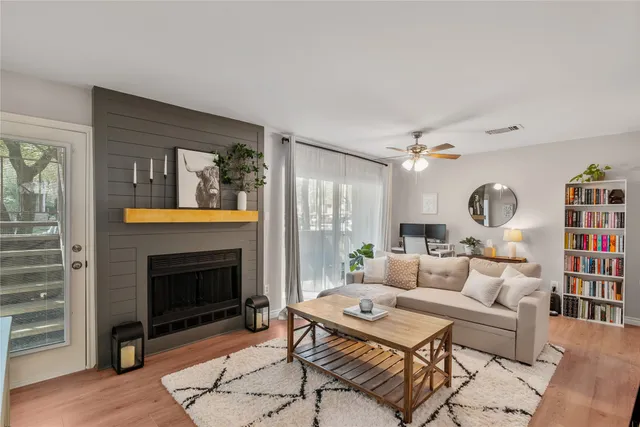 a living room with furniture and a fireplace