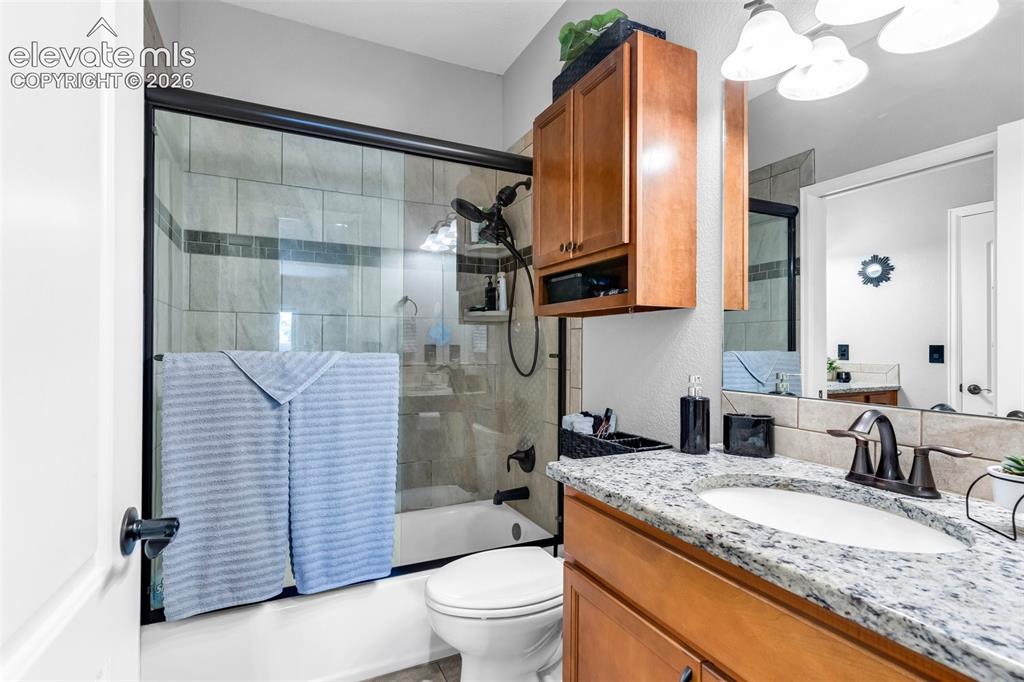 415 Empire Road Canon City, CO 81212 - Photo 23 of 40 a bathroom with a granite countertop sink toilet and shower