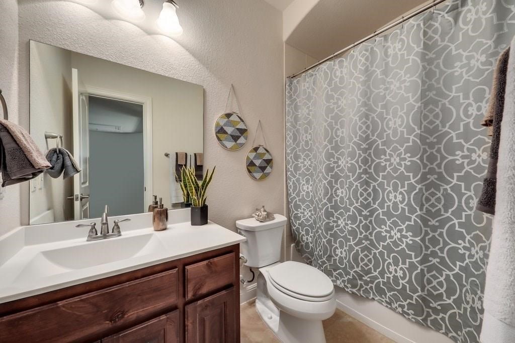10825 Ballard Path Austin, TX 78717 - Photo 30 of 39 a bathroom with a sink toilet and a mirror
