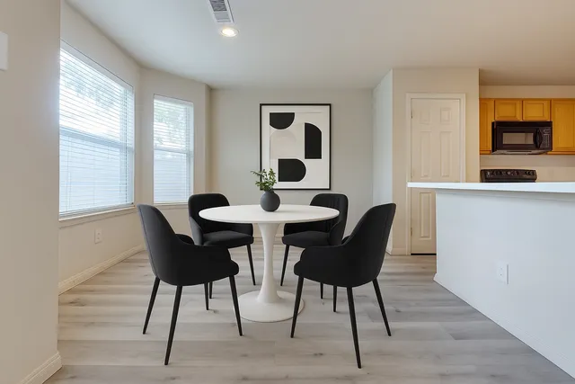 a dining room with furniture and window