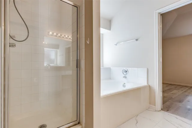 a bathroom with a bathtub and shower