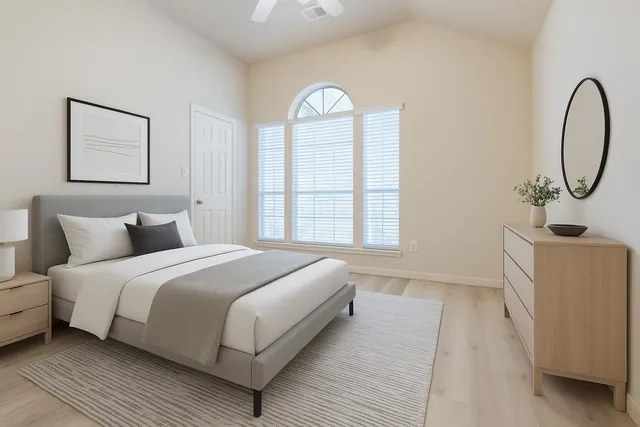 a bedroom with a bed and a window