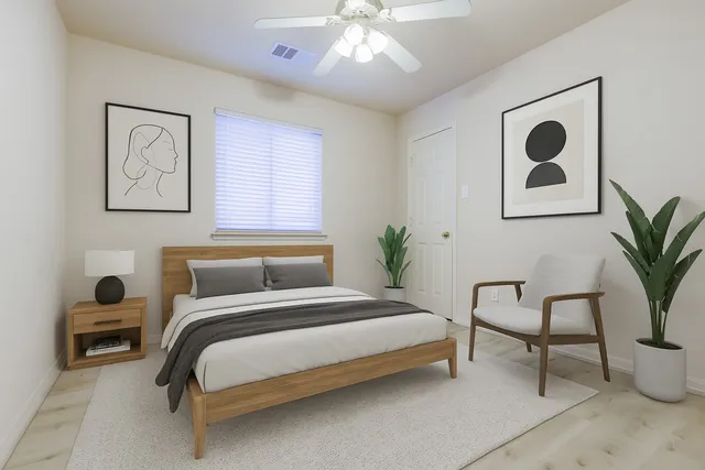 a bedroom with a bed and a chair