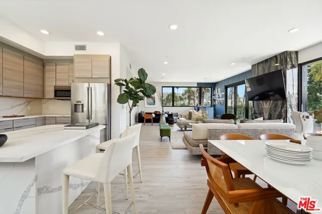 a large kitchen with a table and chairs