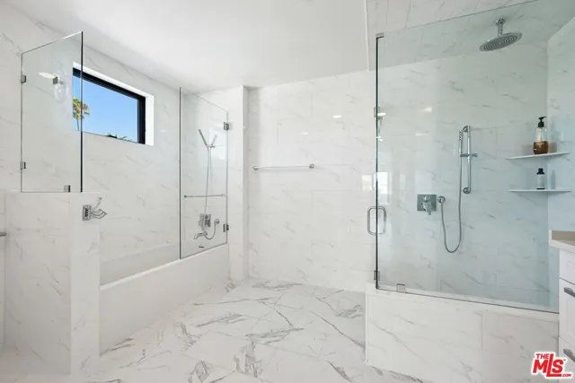 a bathroom with a bathtub and shower