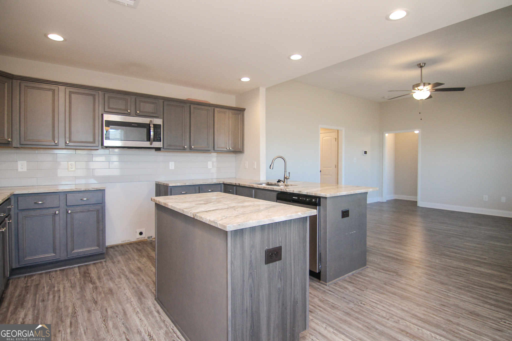 138 Sadie Heights Boulevard Perry, GA 31069 - Photo 11 of 31 a kitchen with a sink and wooden cabinets