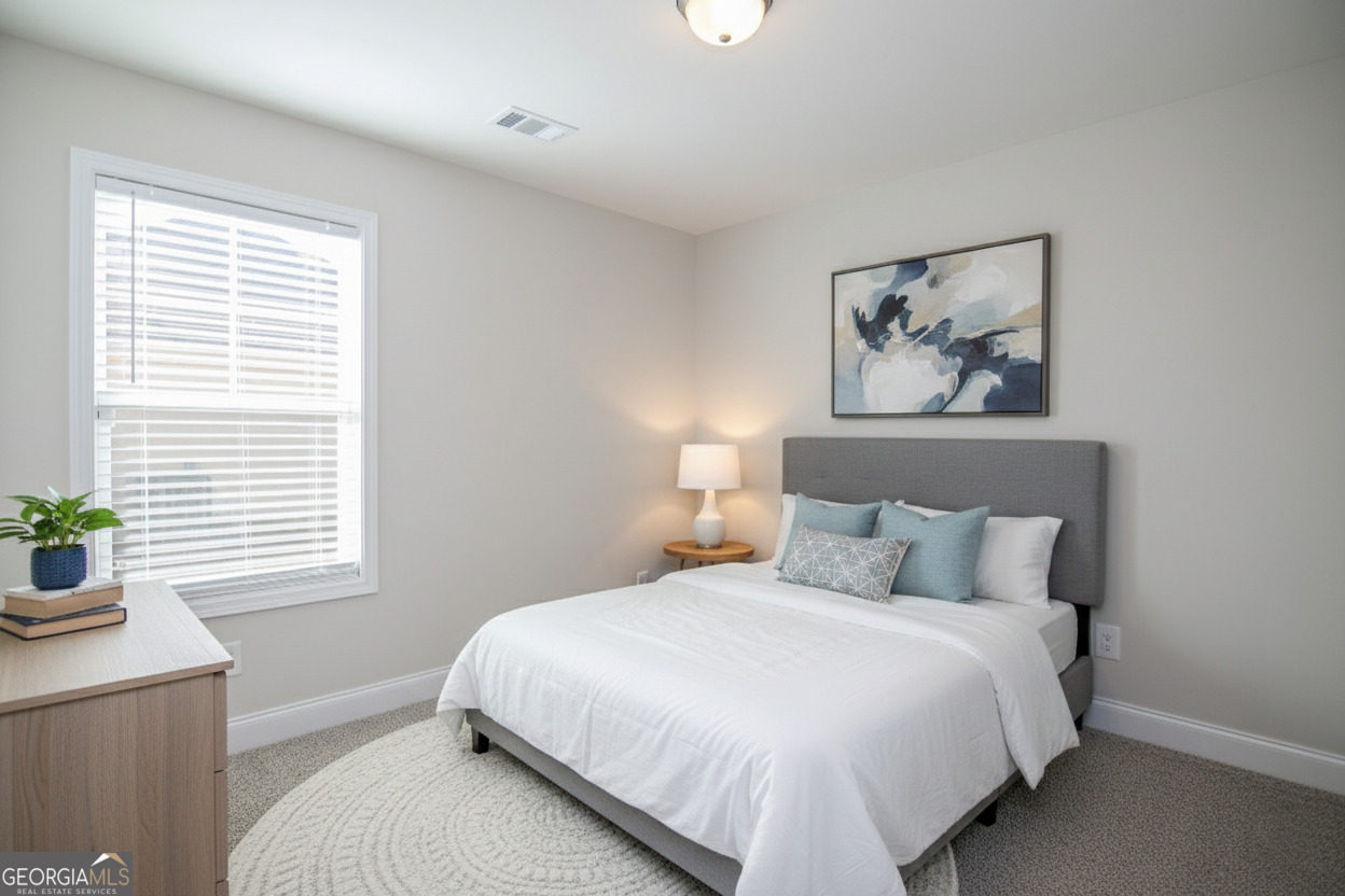 138 Sadie Heights Boulevard Perry, GA 31069 - Photo 15 of 31 a bedroom with a large bed and a window