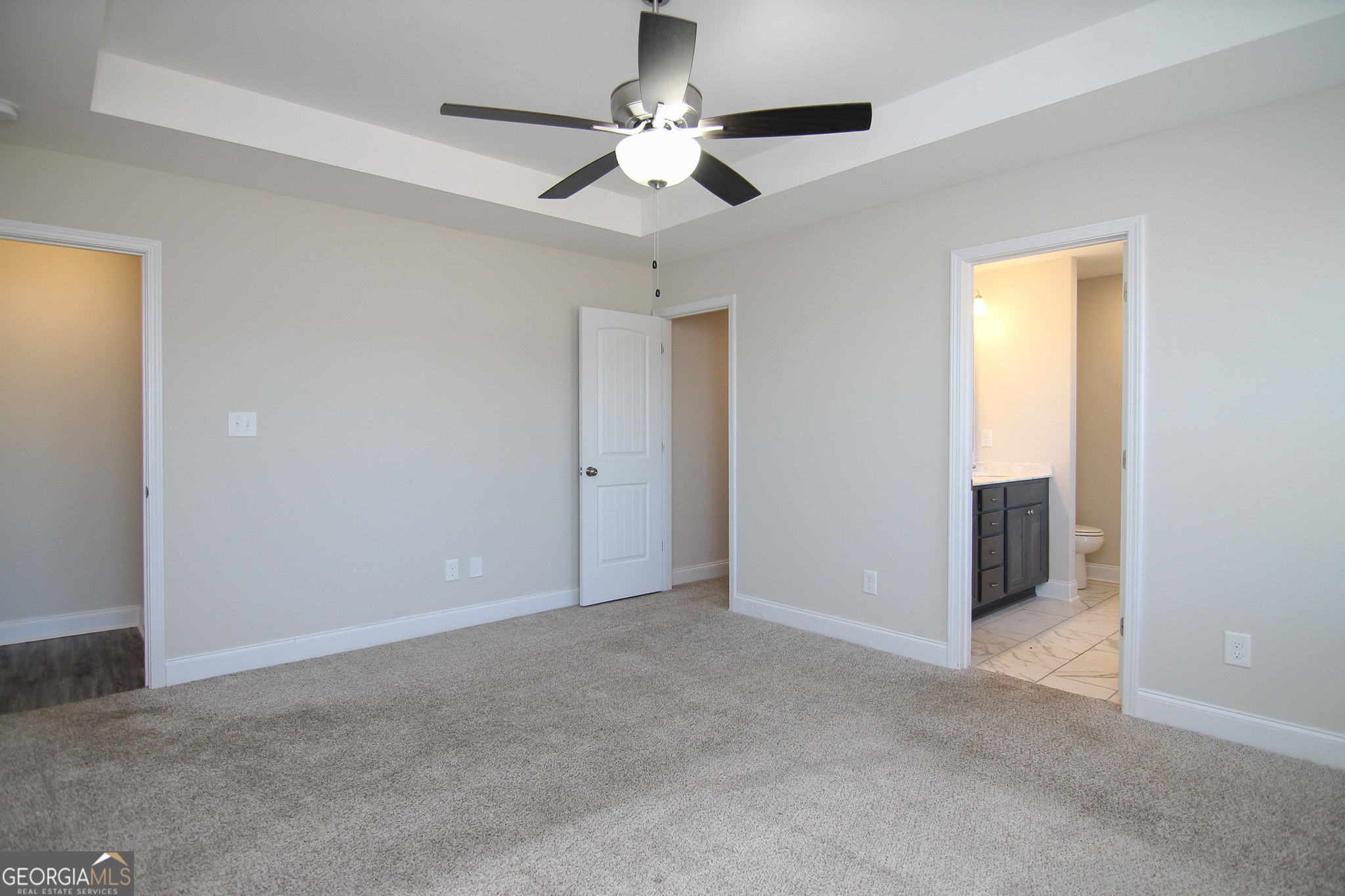 138 Sadie Heights Boulevard Perry, GA 31069 - Photo 17 of 31 a view of an empty room with a ceiling fan
