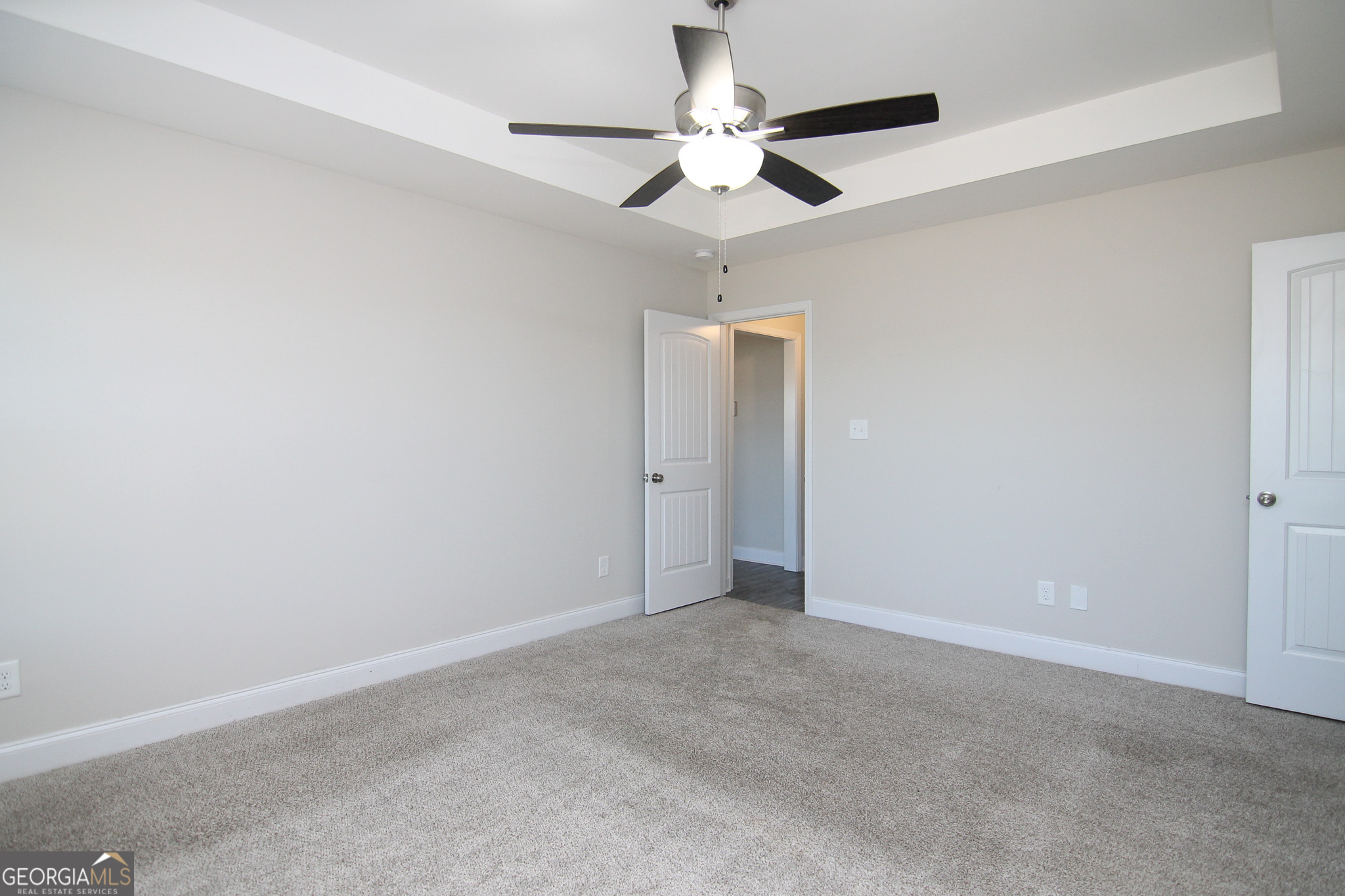 138 Sadie Heights Boulevard Perry, GA 31069 - Photo 18 of 31 an empty room with a ceiling fan and a fan