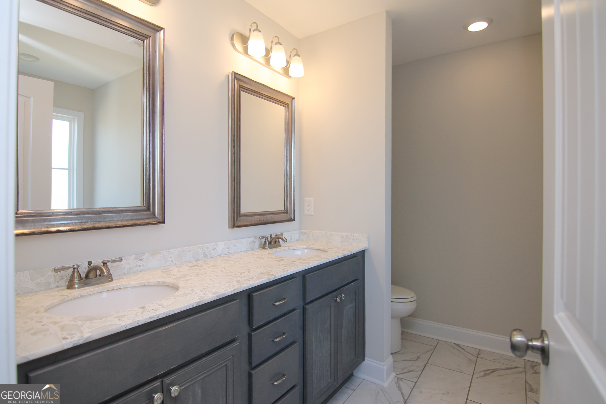 138 Sadie Heights Boulevard Perry, GA 31069 - Photo 19 of 31 a bathroom with a granite countertop sink mirror and toilet