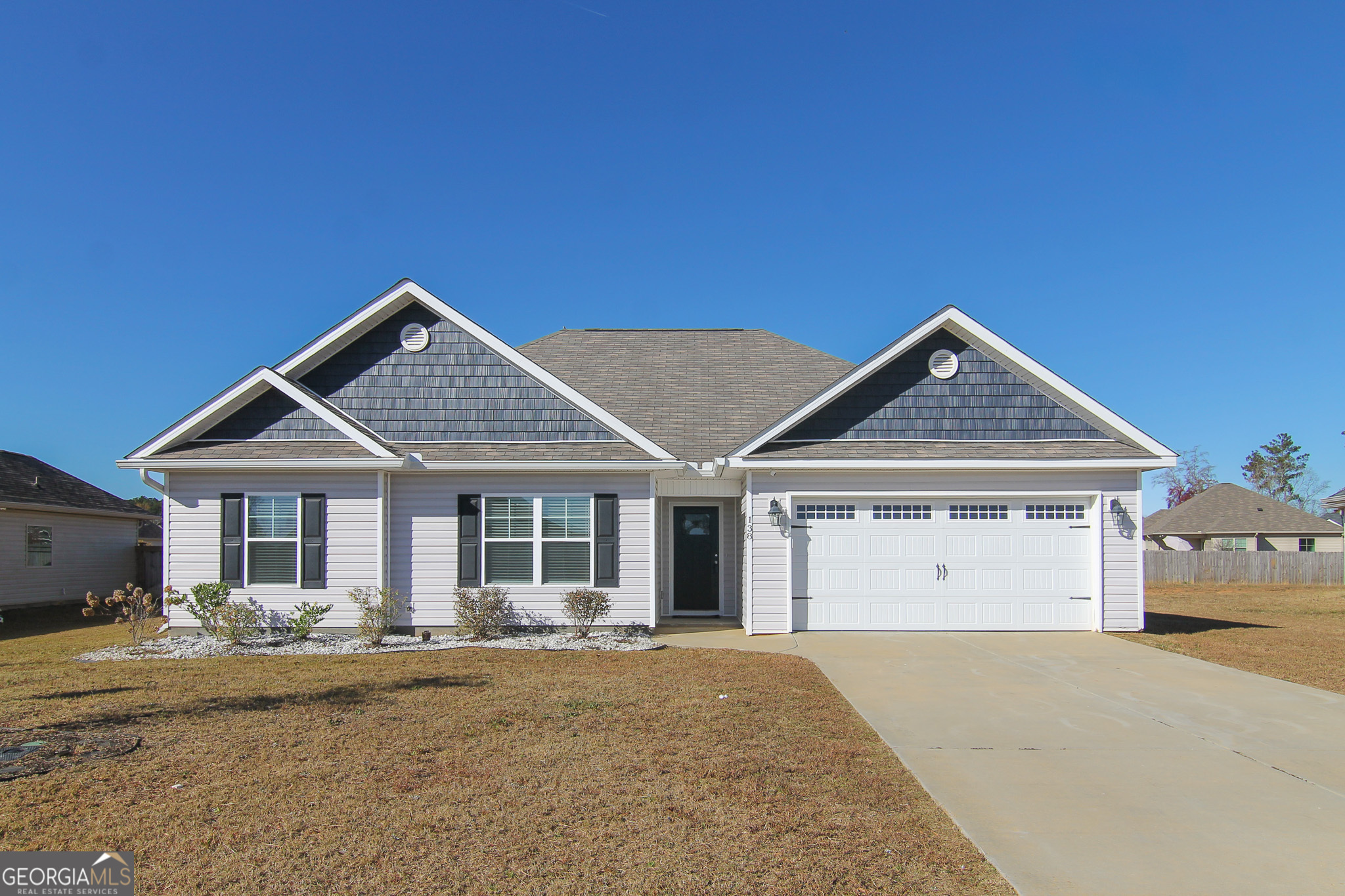 138 Sadie Heights Boulevard Perry, GA 31069 - Photo 2 of 31 a front view of a house with a yard and garage