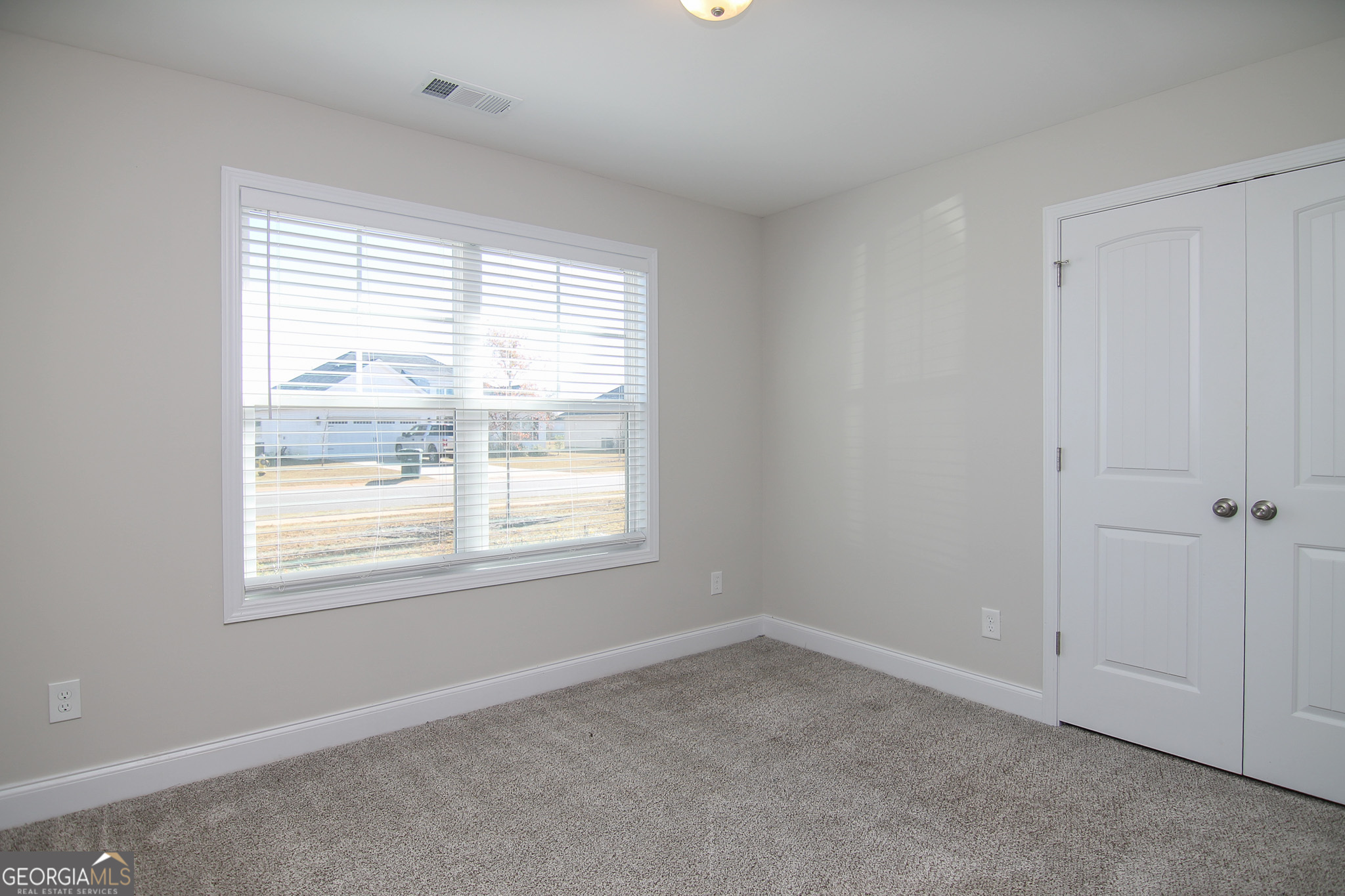 138 Sadie Heights Boulevard Perry, GA 31069 - Photo 22 of 31 an empty room with a window