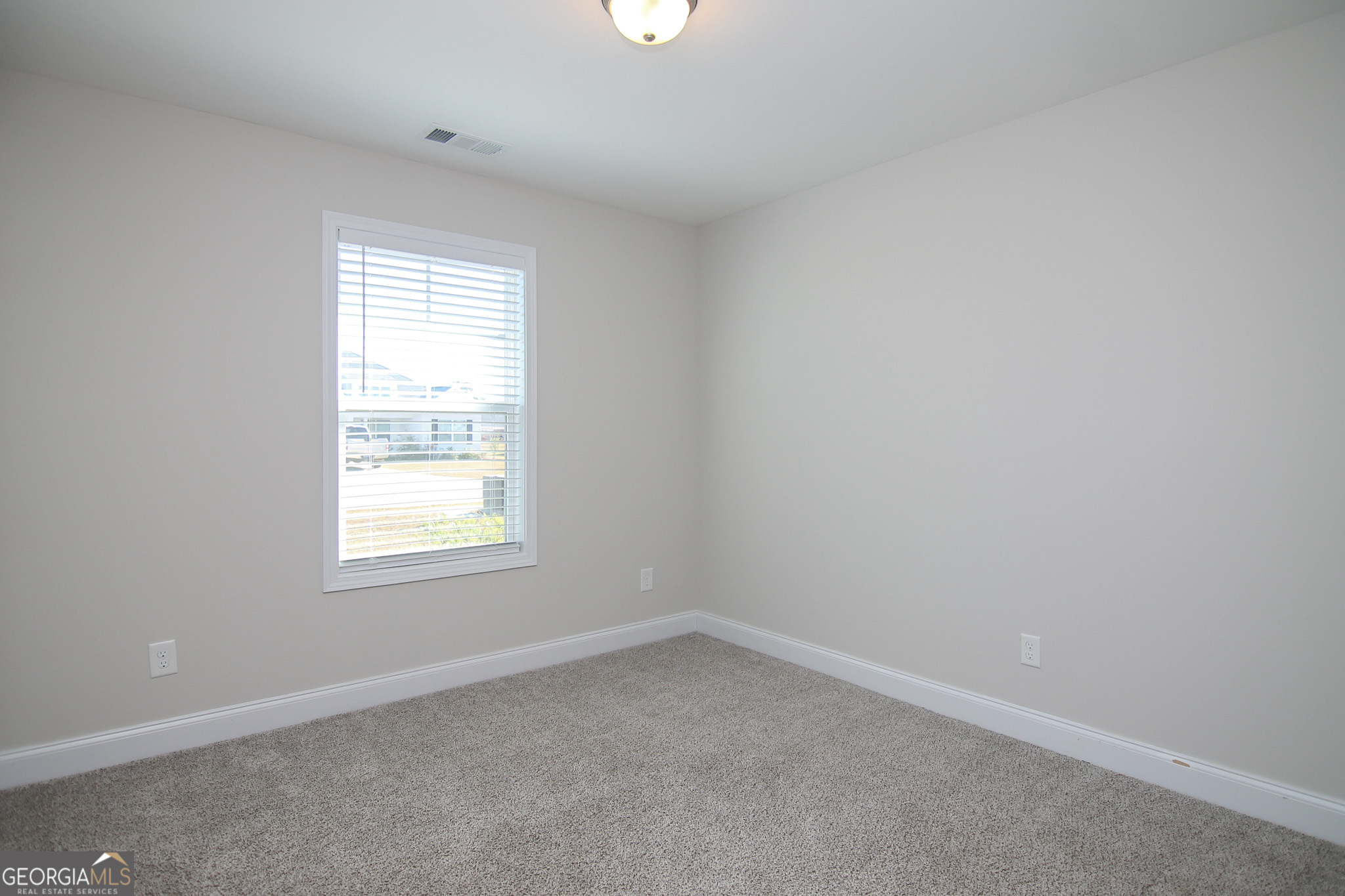 138 Sadie Heights Boulevard Perry, GA 31069 - Photo 25 of 31 an empty room with a window