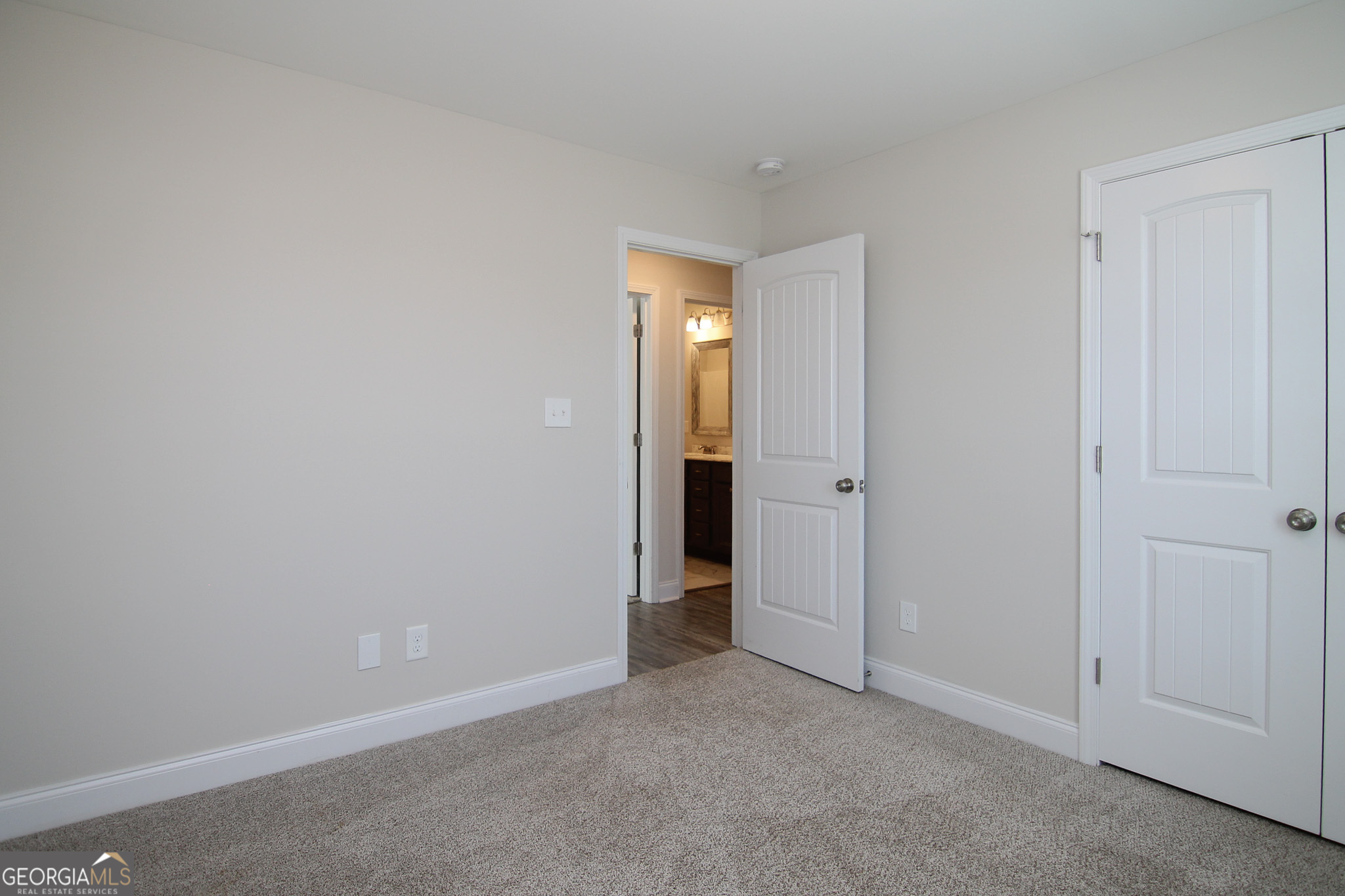138 Sadie Heights Boulevard Perry, GA 31069 - Photo 26 of 31 a view of an empty room with closet and wooden door