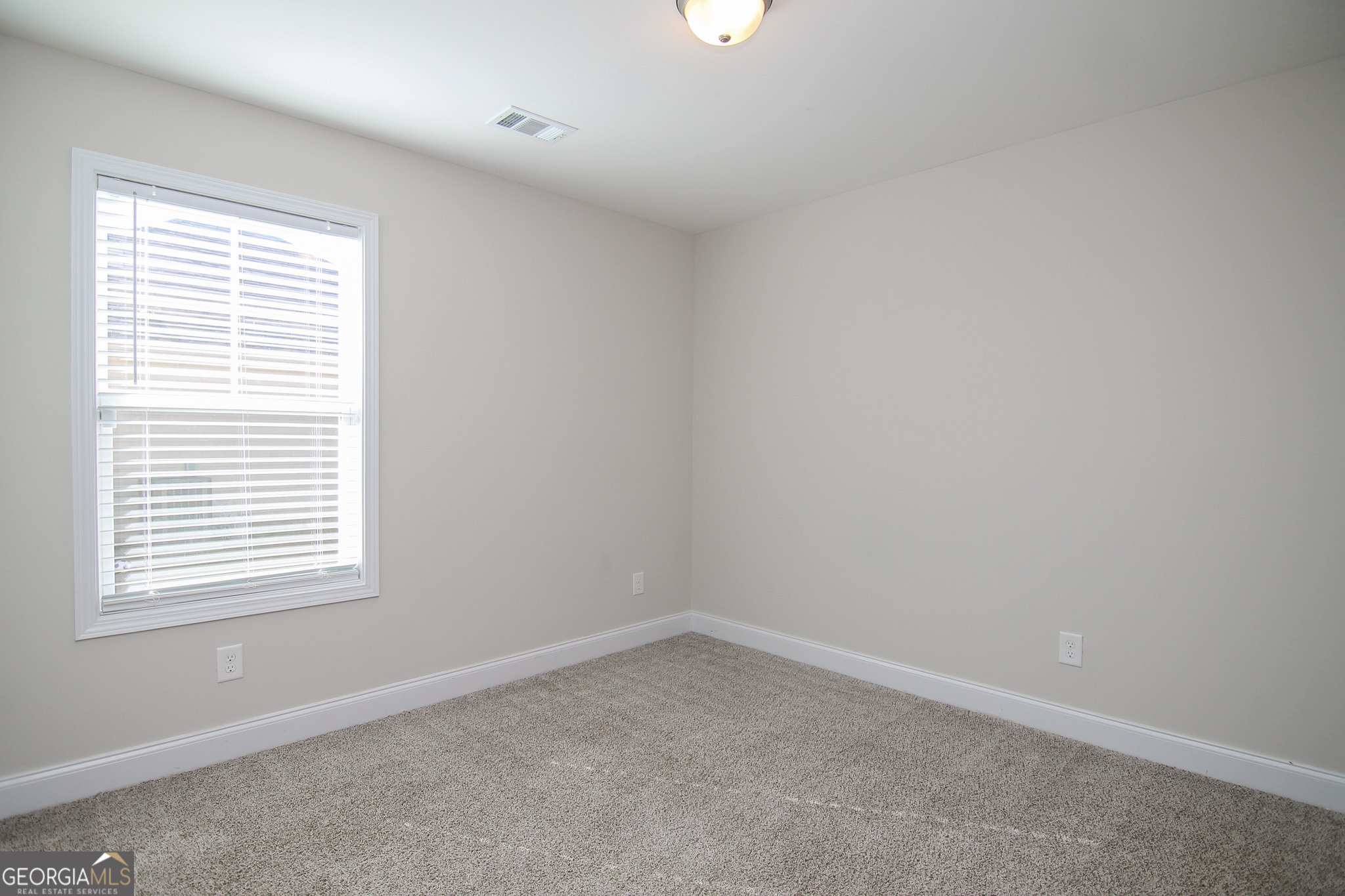 138 Sadie Heights Boulevard Perry, GA 31069 - Photo 28 of 31 an empty room with a window