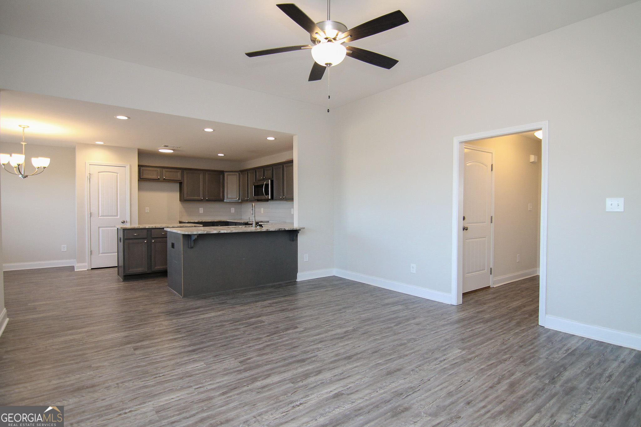 138 Sadie Heights Boulevard Perry, GA 31069 - Photo 6 of 31 a view of kitchen with kitchen island wooden floor center island and stainless steel appliances