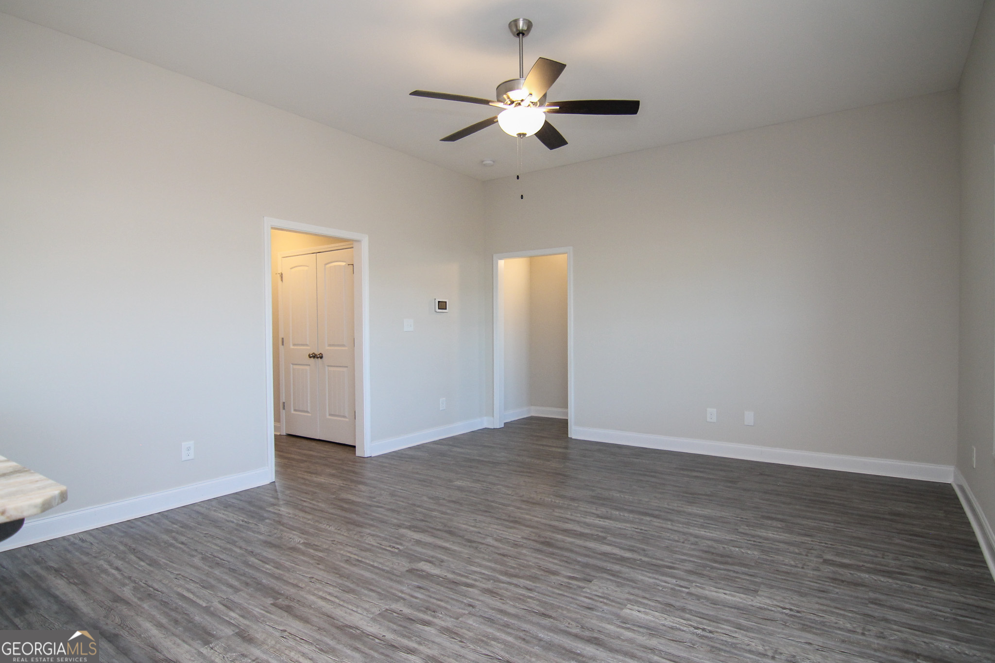 138 Sadie Heights Boulevard Perry, GA 31069 - Photo 7 of 31 a view of an empty room with wooden floor