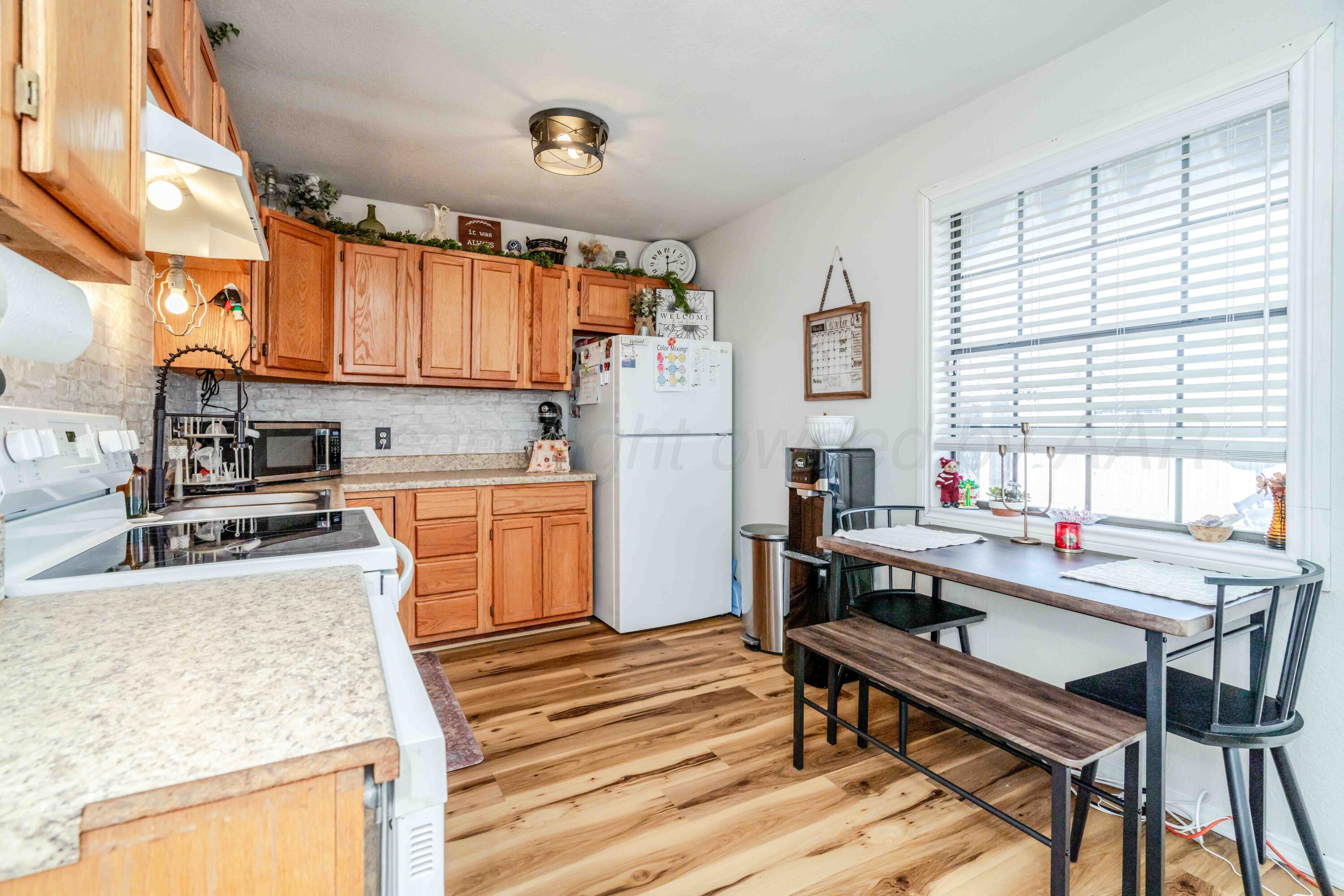 1505 Hamilton Street Pampa, TX 79065 - Photo 12 of 42 a kitchen with a stove a refrigerator and a dining table