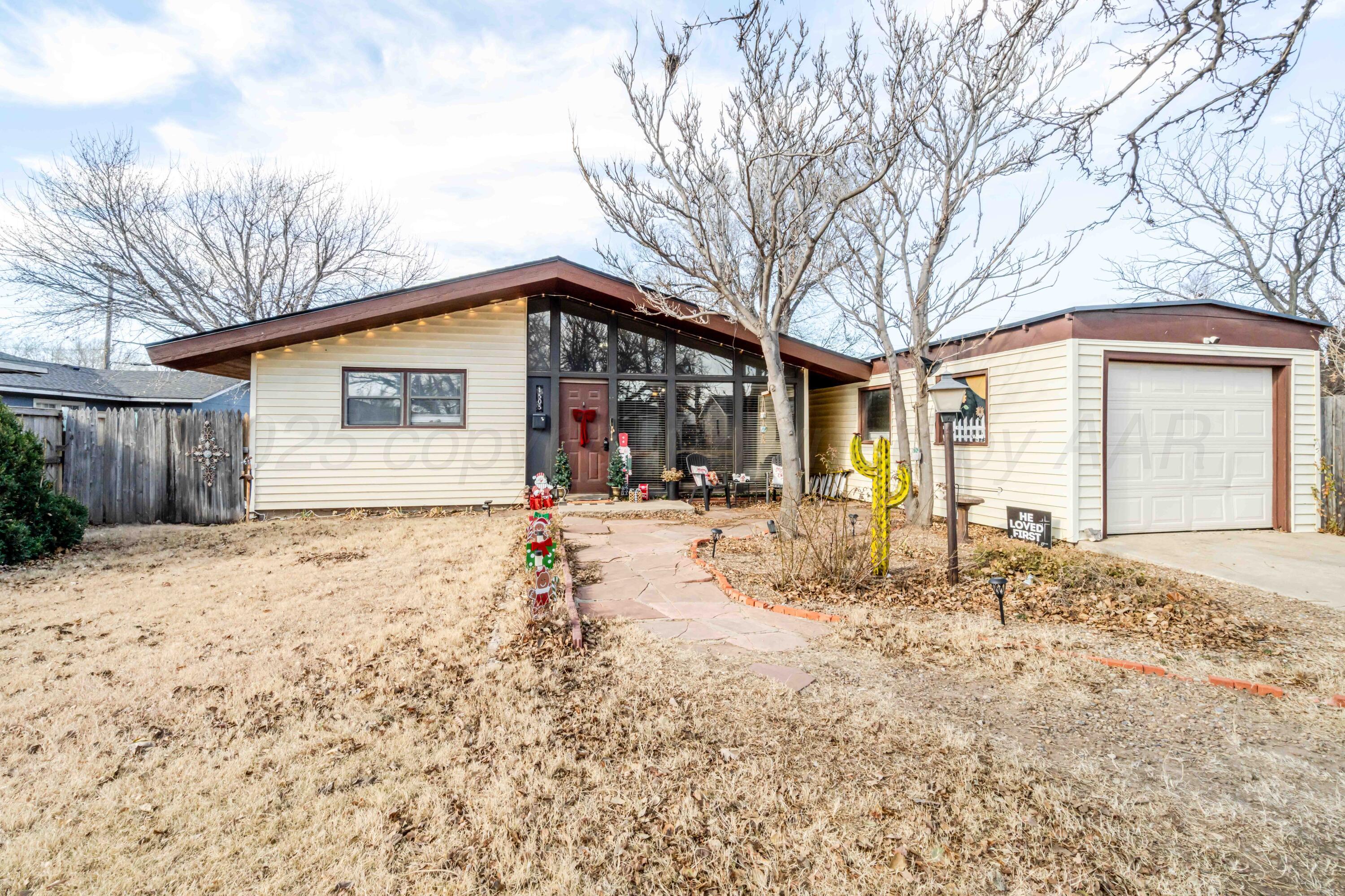 1505 Hamilton Street Pampa, TX 79065 - Photo 2 of 42 a front view of a house with a yard and garage