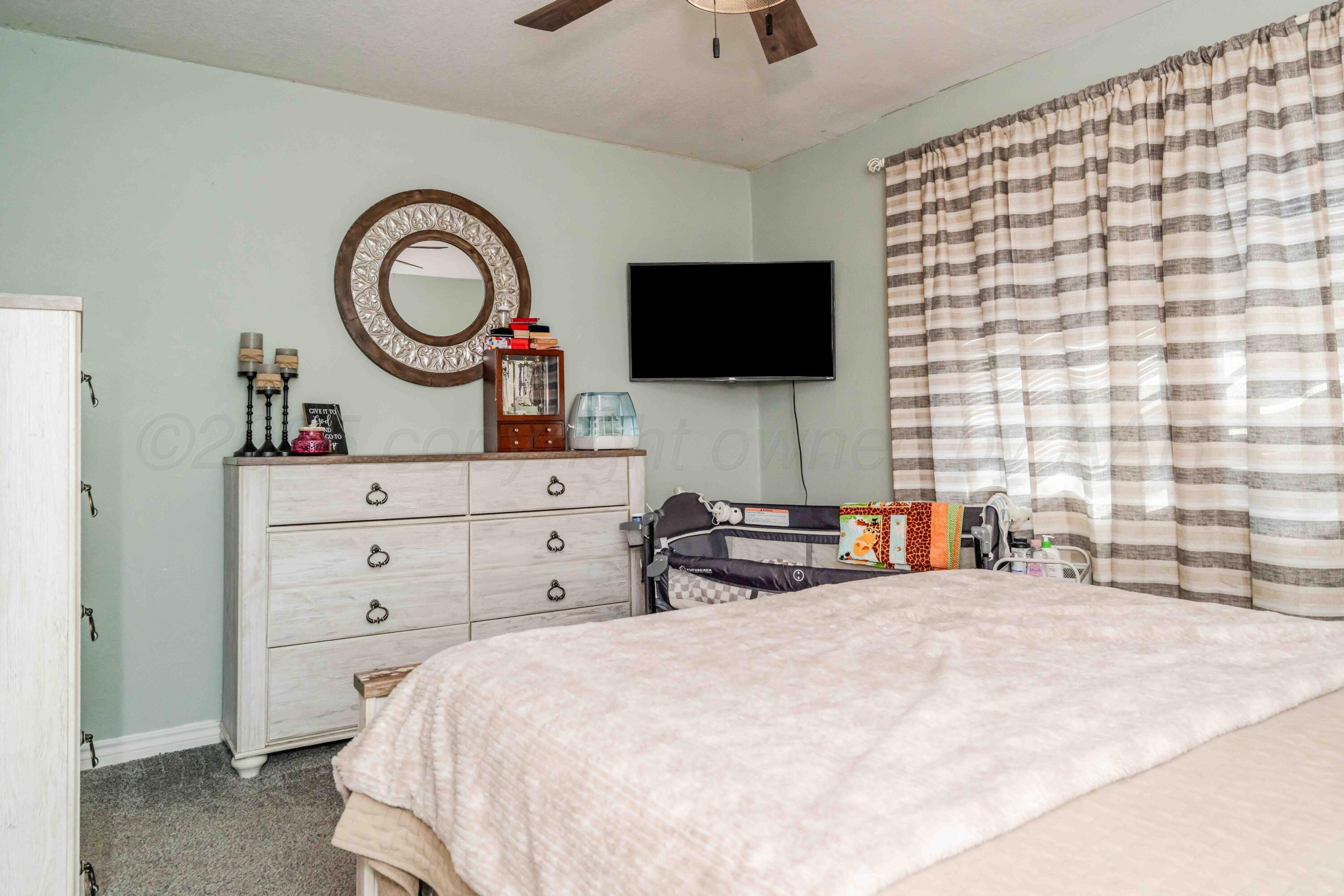 1505 Hamilton Street Pampa, TX 79065 - Photo 21 of 42 a bedroom with a bed and a flat screen tv