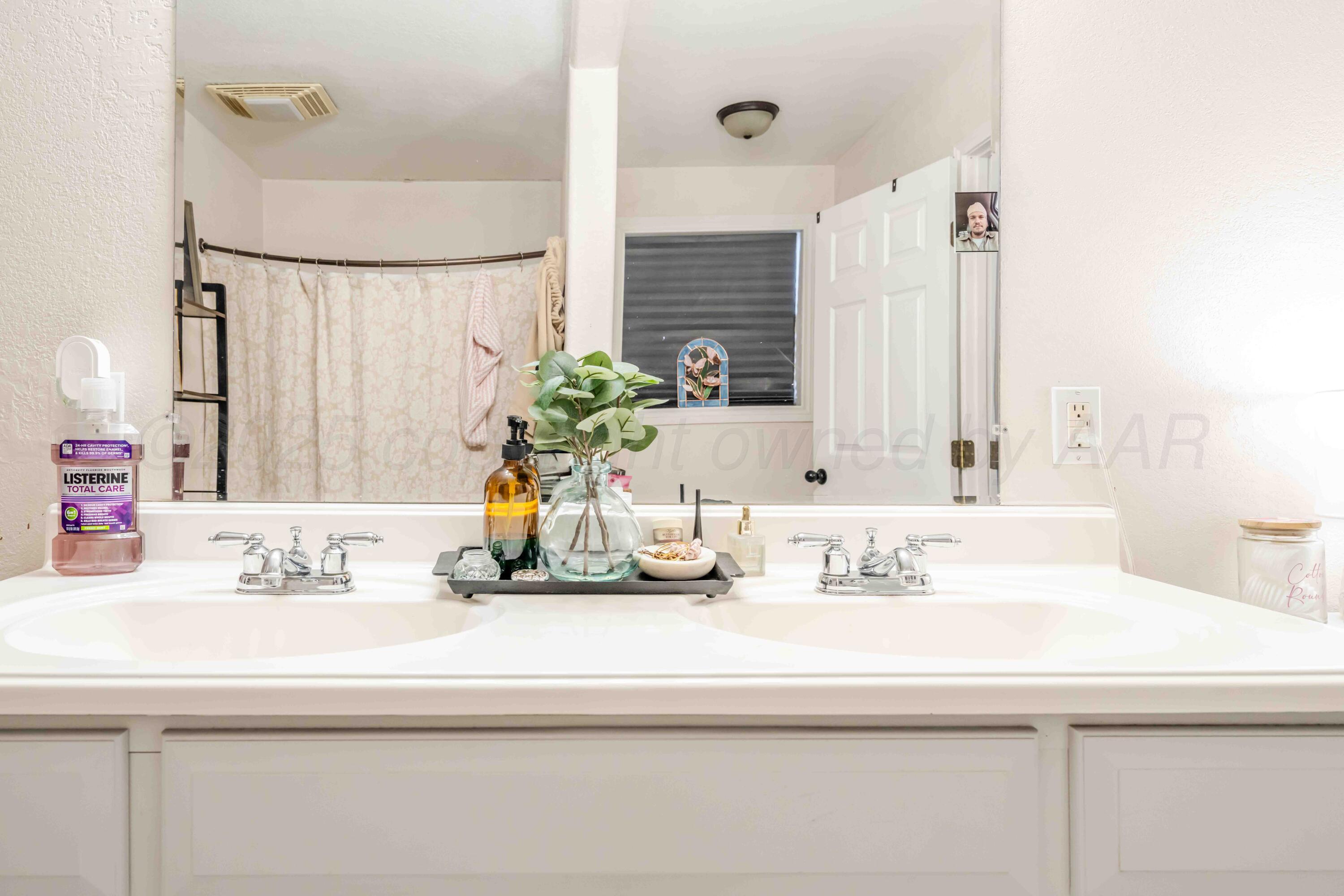1505 Hamilton Street Pampa, TX 79065 - Photo 26 of 42 a bathroom with a sink and a mirror