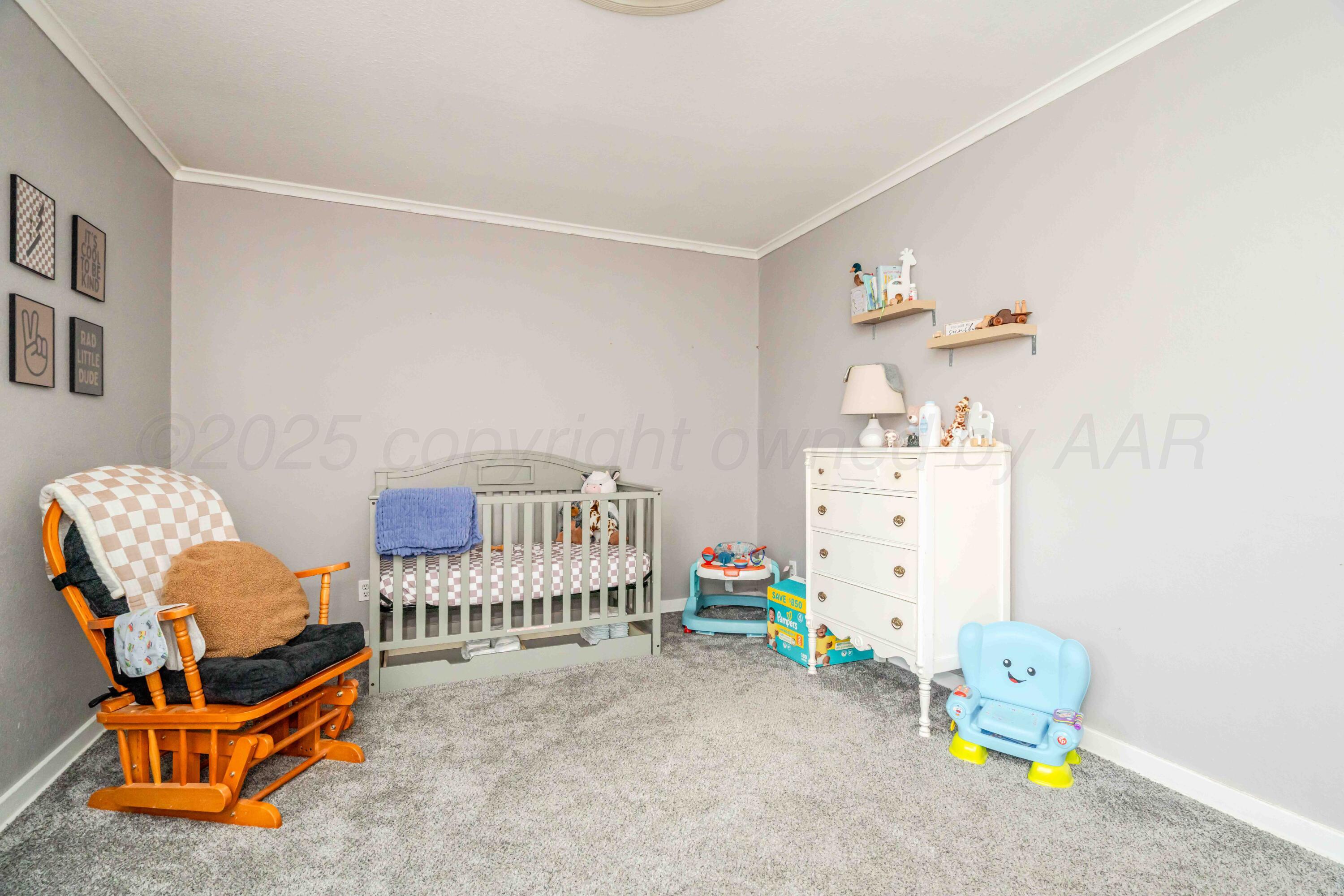 1505 Hamilton Street Pampa, TX 79065 - Photo 29 of 42 a living room with baby crib furniture and a lamp