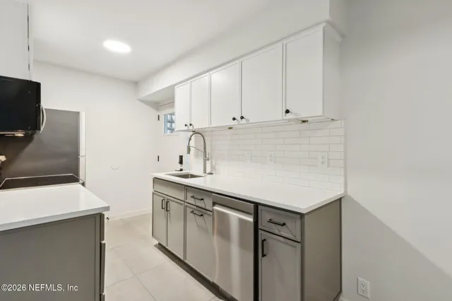 a kitchen with stainless steel appliances cabinets a sink and a stove