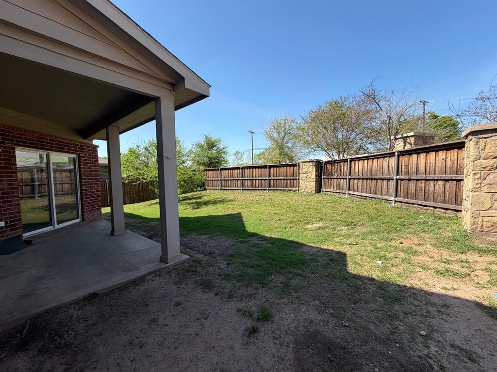 10400 Wagon Rut Court Fort Worth, TX 76108 - Photo 6 of 26 Fenced backyard with a patio area