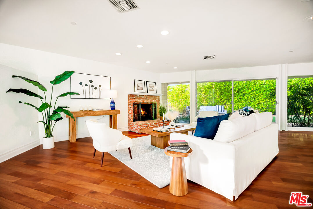 16561 Adlon Road Encino, CA 91436 - Photo 12 of 75 a living room with furniture large window and a wooden floor