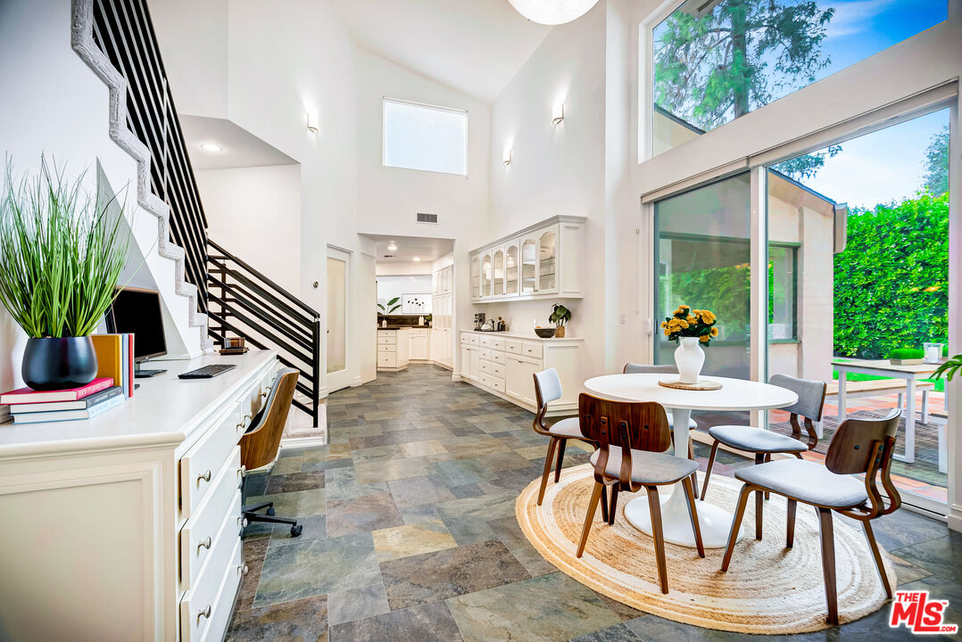 16561 Adlon Road Encino, CA 91436 - Photo 22 of 75 a view of a dining room with furniture and a potted plant