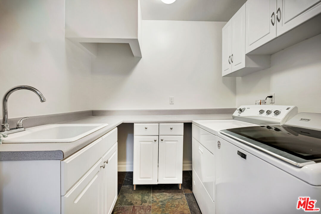 16561 Adlon Road Encino, CA 91436 - Photo 25 of 75 a kitchen with a sink cabinets and appliances