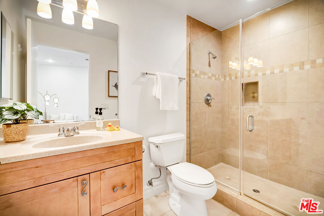 16561 Adlon Road Encino, CA 91436 - Photo 29 of 75 a bathroom with a sink a toilet and shower