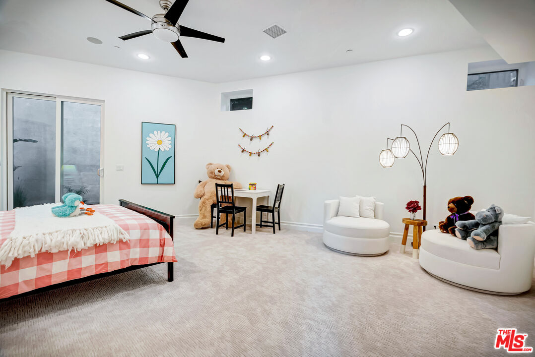 16561 Adlon Road Encino, CA 91436 - Photo 30 of 75 a bedroom with a bed and a chandelier