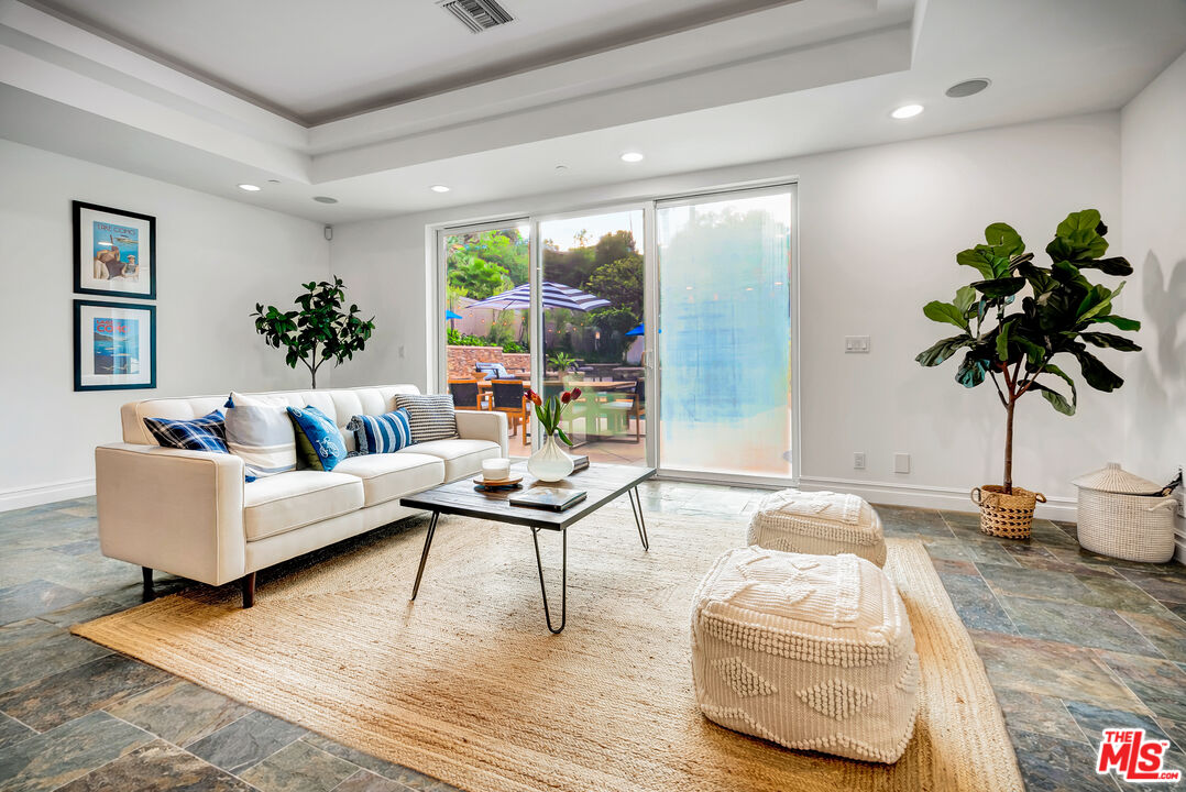 16561 Adlon Road Encino, CA 91436 - Photo 33 of 75 a living room with furniture and a potted plant