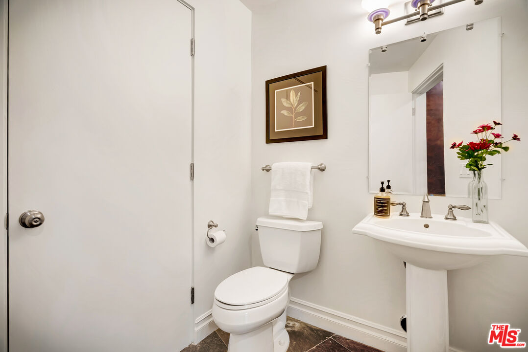 16561 Adlon Road Encino, CA 91436 - Photo 35 of 75 a bathroom with a toilet sink and mirror