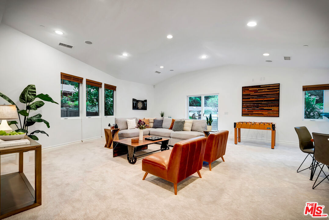 16561 Adlon Road Encino, CA 91436 - Photo 40 of 75 a living room with furniture and large windows