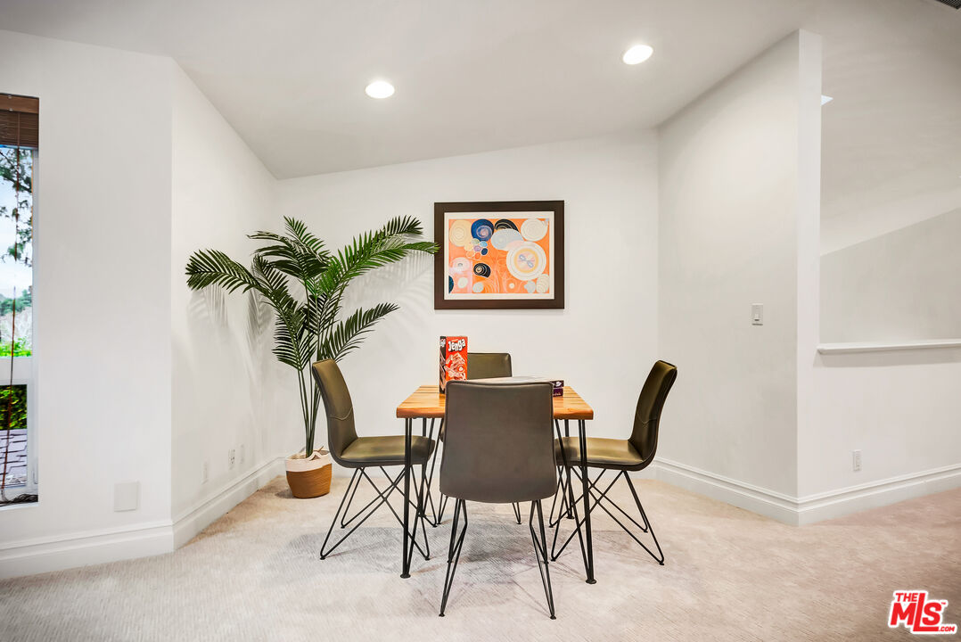 16561 Adlon Road Encino, CA 91436 - Photo 41 of 75 a view of a dining room with furniture and a potted plant