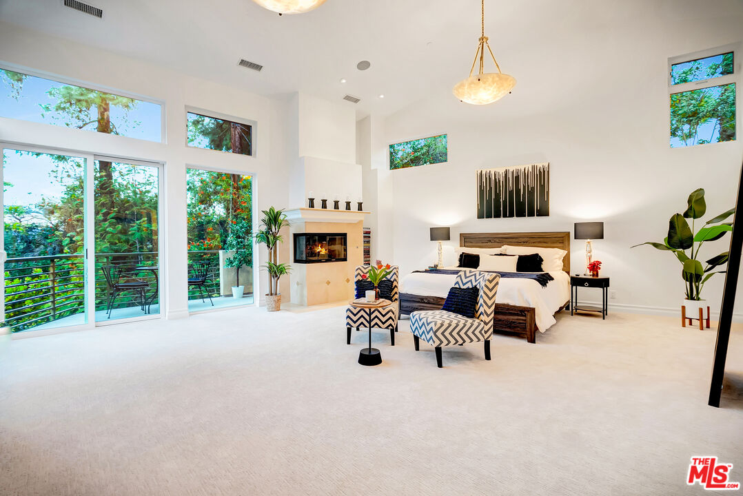 16561 Adlon Road Encino, CA 91436 - Photo 44 of 75 a living room with furniture a fireplace and a large window