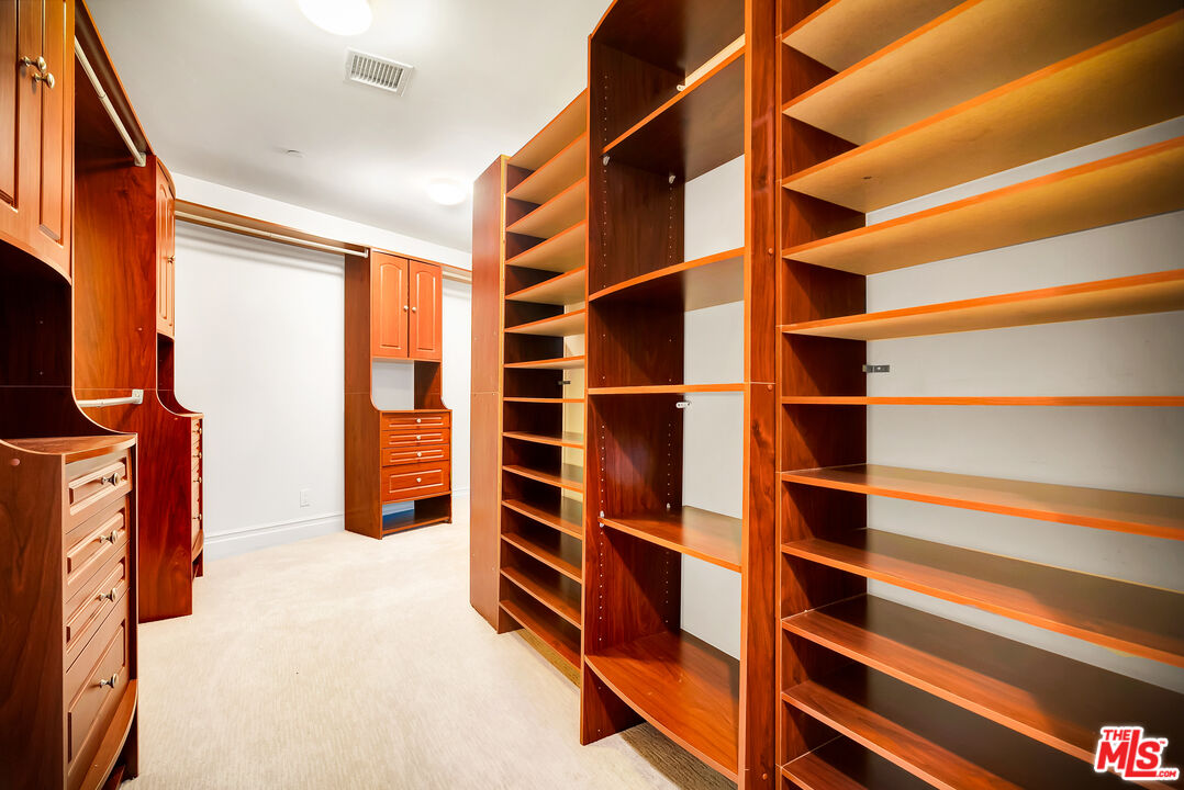 16561 Adlon Road Encino, CA 91436 - Photo 49 of 75 a view of walk in closet with clothes and shoes