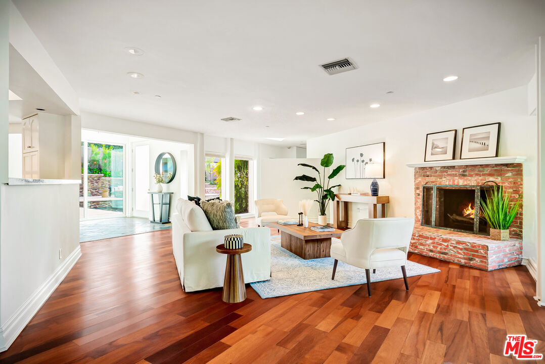 16561 Adlon Road Encino, CA 91436 - Photo 50 of 75 a living room with furniture and a fireplace
