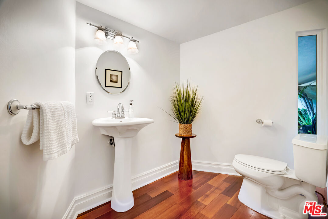 16561 Adlon Road Encino, CA 91436 - Photo 51 of 75 a bathroom with a sink toilet and a mirror